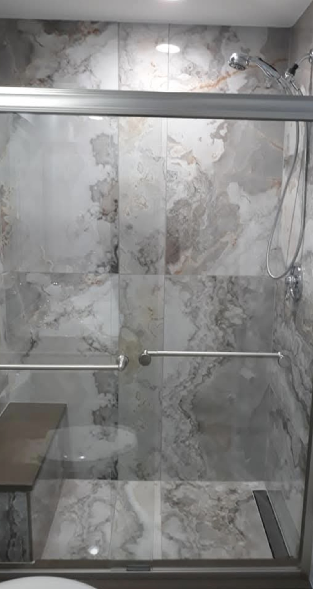 Bathroom with glass shower, subway tile and black vanity