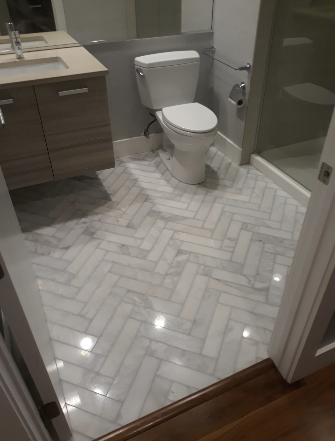 Remodeled bathroom with herringbone marble floor