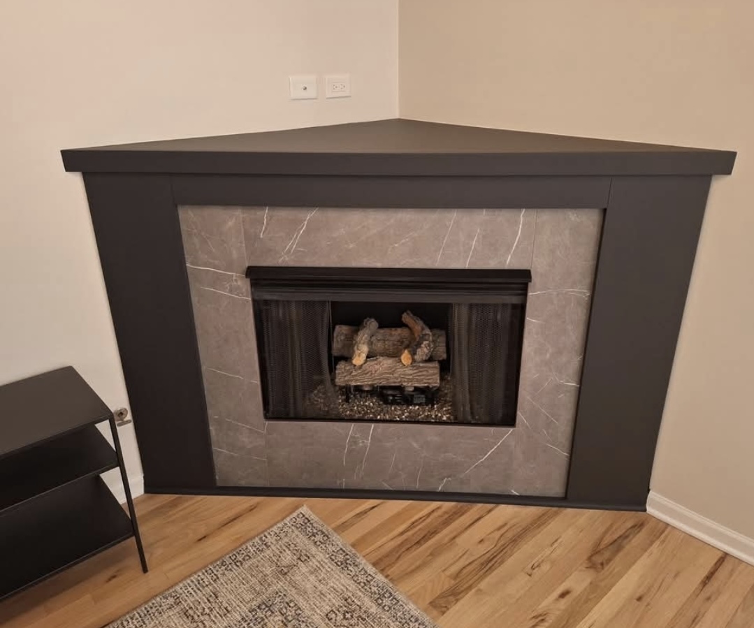 Corner gas fireplace with tile surround and floating mantel