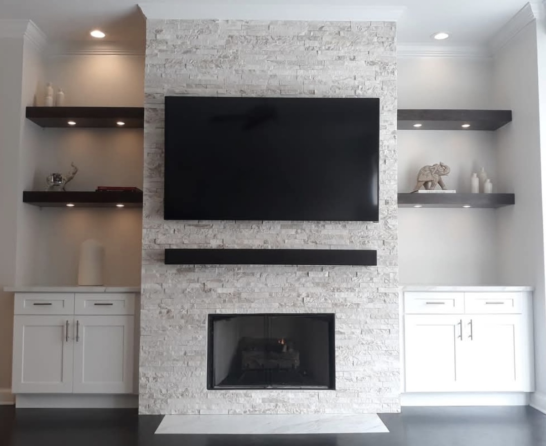 Finished stacked-stone fireplace with built-ins, a GH1 Construction remodel