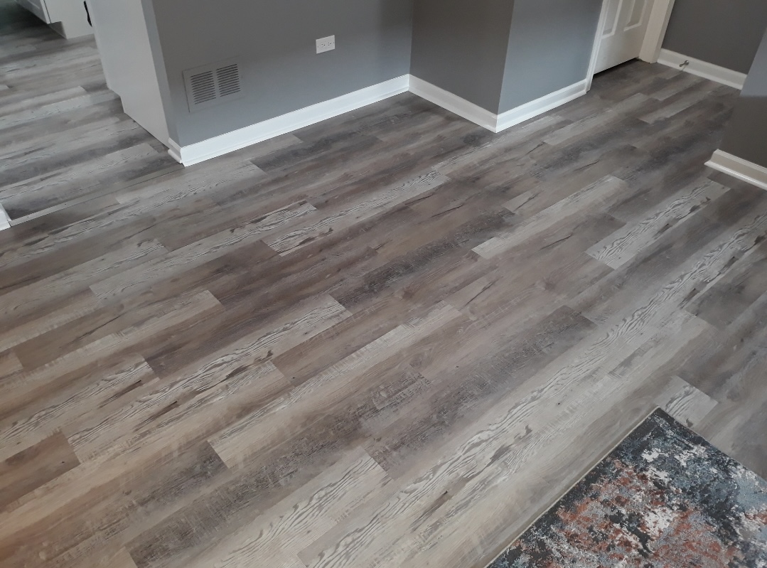 Room with new gray vinyl plank flooring