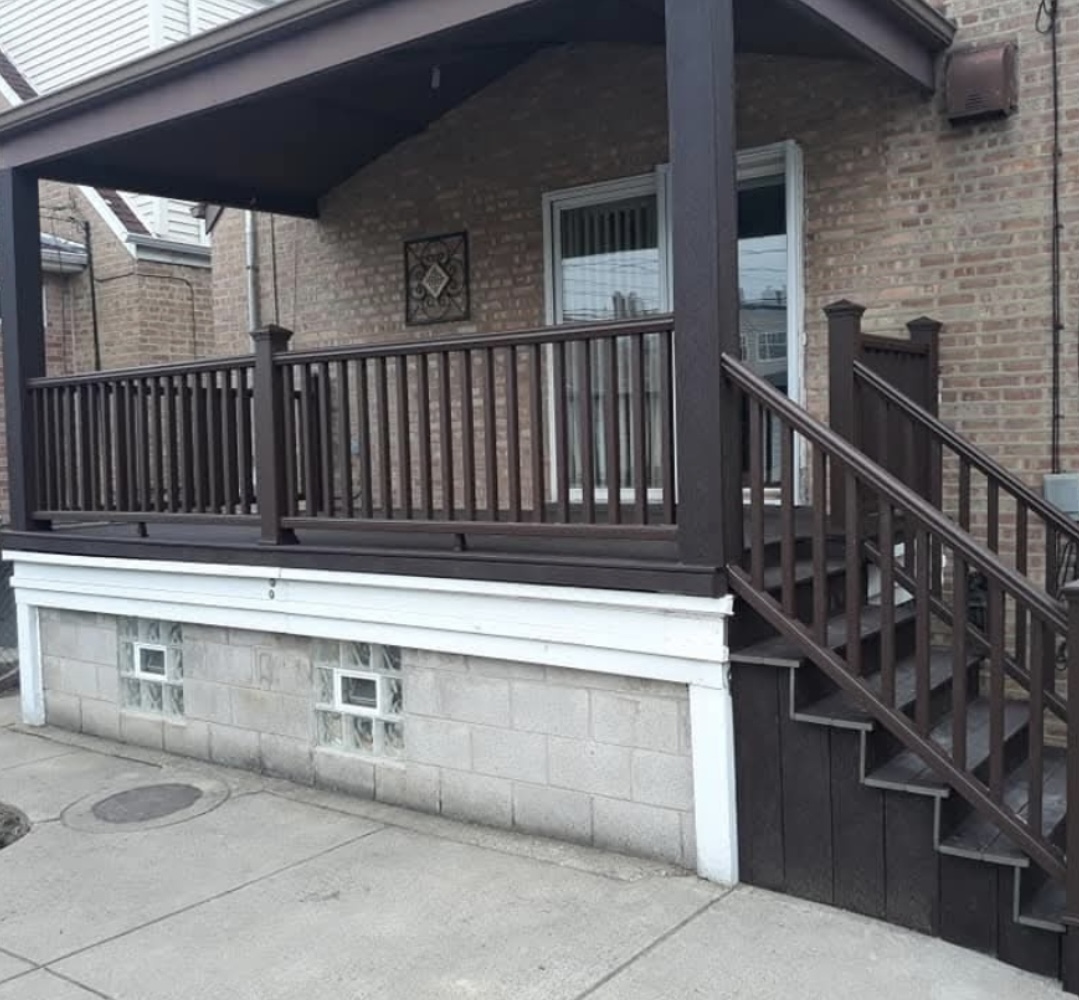Brick porch with railing and stairs